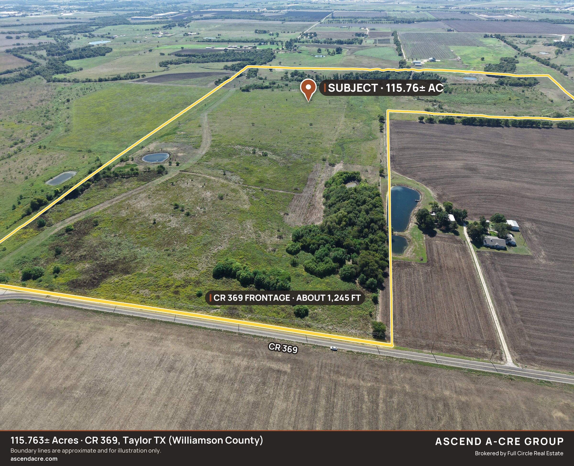 Drone aerial looking south across CR 369 at the full 115.763-acre tract and its road frontage, boundary drawn